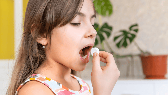 child eating chewable tablet