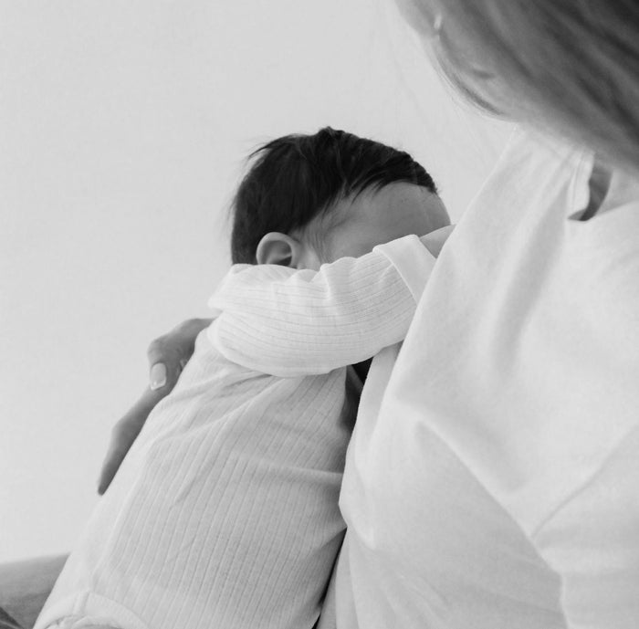 A baby using hand while feeding.
