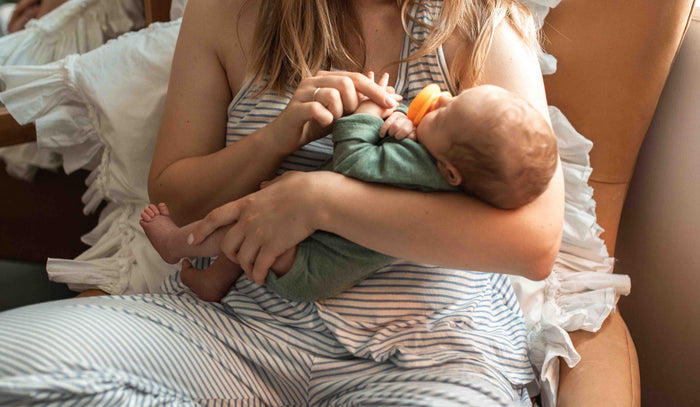 A mom is holding her small baby