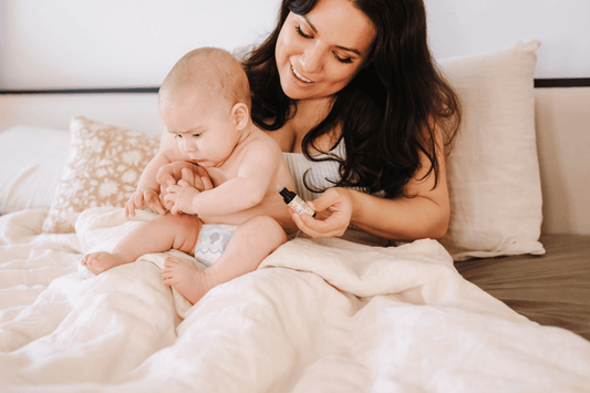 Mother giving baby D3 and K2