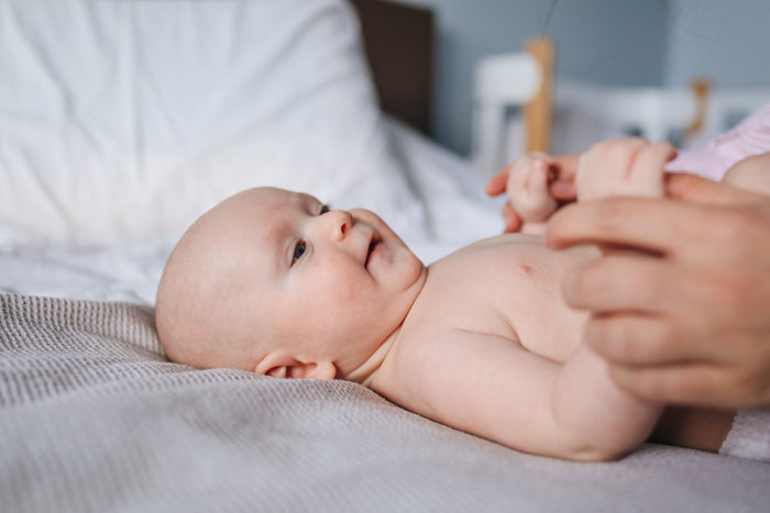 A woman is feeding her baby a bottle